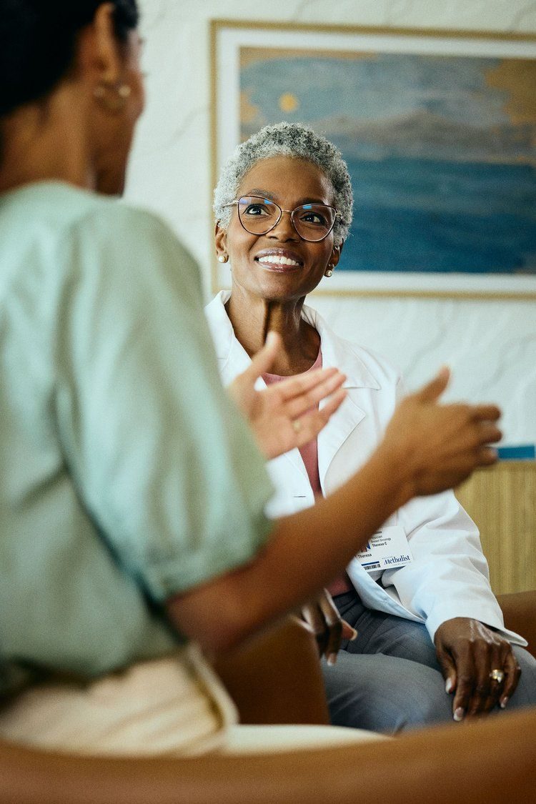 Clinician talking with a patient in a consultation room